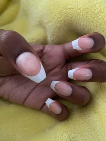 reviewer wearing French manicure style press on nails