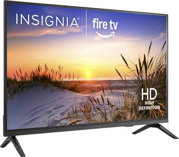 Insignia HD TV with Fire TV interface connected screen, showing a serene formation sunset image. Featured successful a buying article