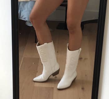 reviewer posing in solid white cowboy boots