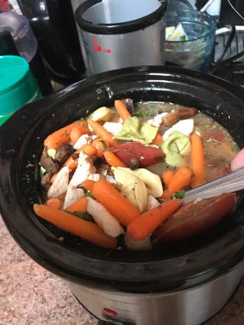 Reviewer showing off the soup they made in the slow cooker