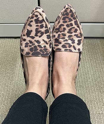 reviewer wearing the leopard print loafers