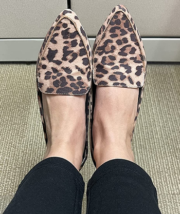reviewer wearing the leopard print loafers