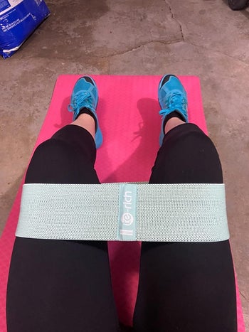 thick light blue resistance band around another reviewer's thighs