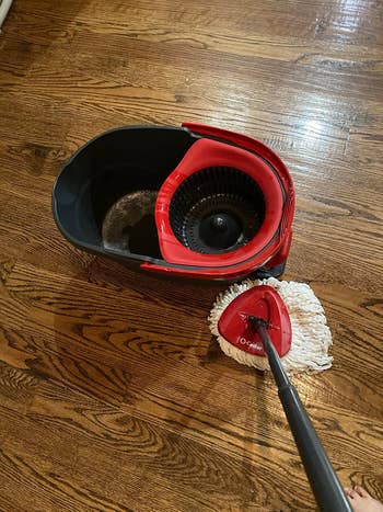 Mop and bucket set with wringer on wooden floor