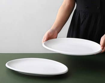 model holding oval serving plate