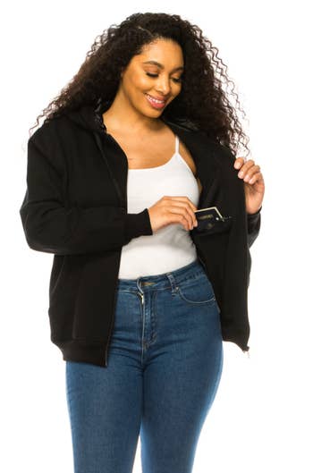 a model wearing the black zip up showing the internal hidden pockets