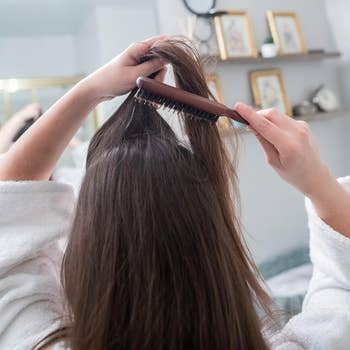 a model using the teasing comb to do their hair