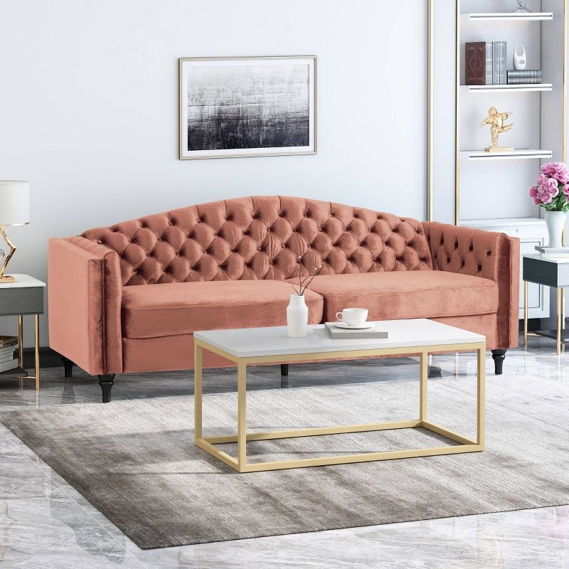 pink tufted velvet couch in a living room