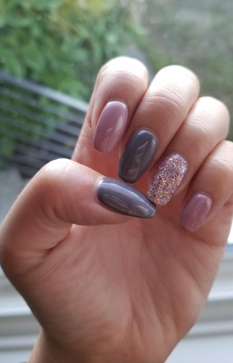 Reviewer's nails in different shades of purple and glitter