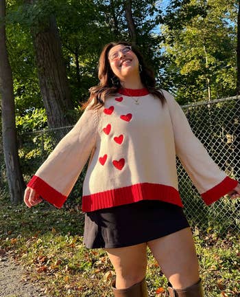 model showing the front side of the white and red hearts sweater