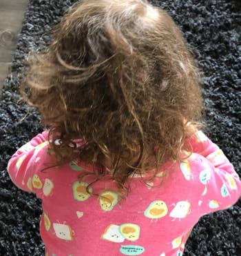 Reviewer's child's messy hair before using the spray 