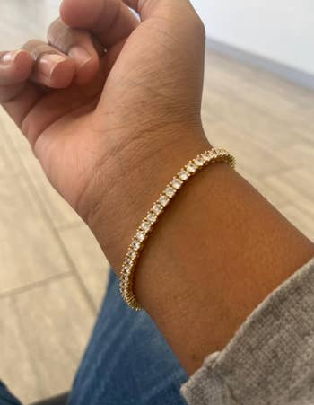 reviewer wearing gold plated bracelet
