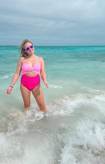 reviewer wearing the swimsuit in light pink and bright pink