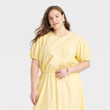 Model in a casual yellow dress with a round neckline and gathered sleeves