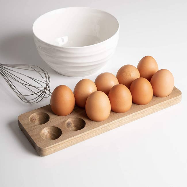 the wooden holder with spots to hold 12 eggs