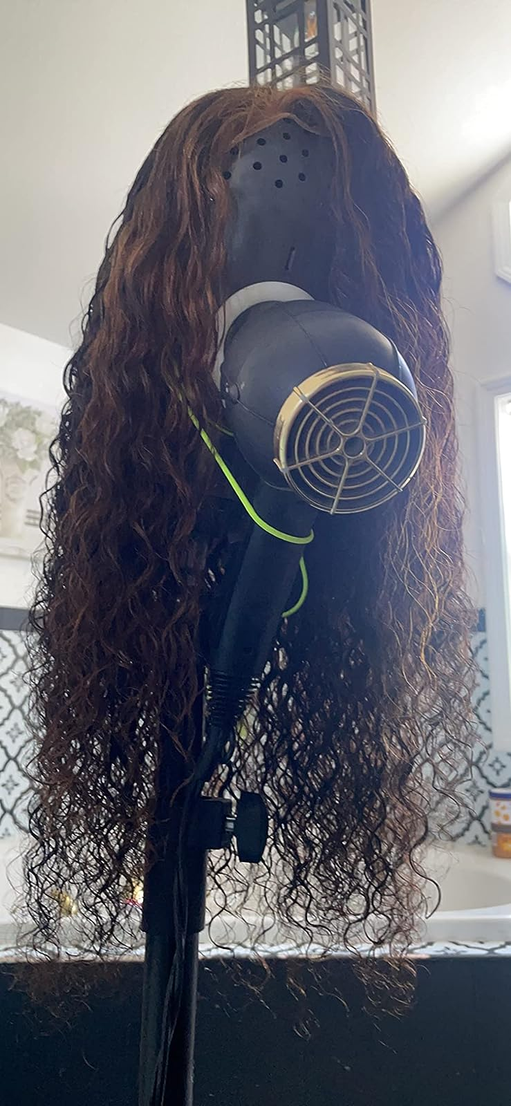 another reviewer photo of a wig on the stand and a dryer in the hole