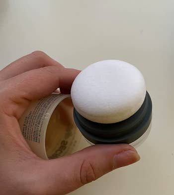 Reviewer holding the dry shampoo applicator