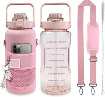 the pink water bottle with phone in sleeve and keys attached next to strap and bottle brush