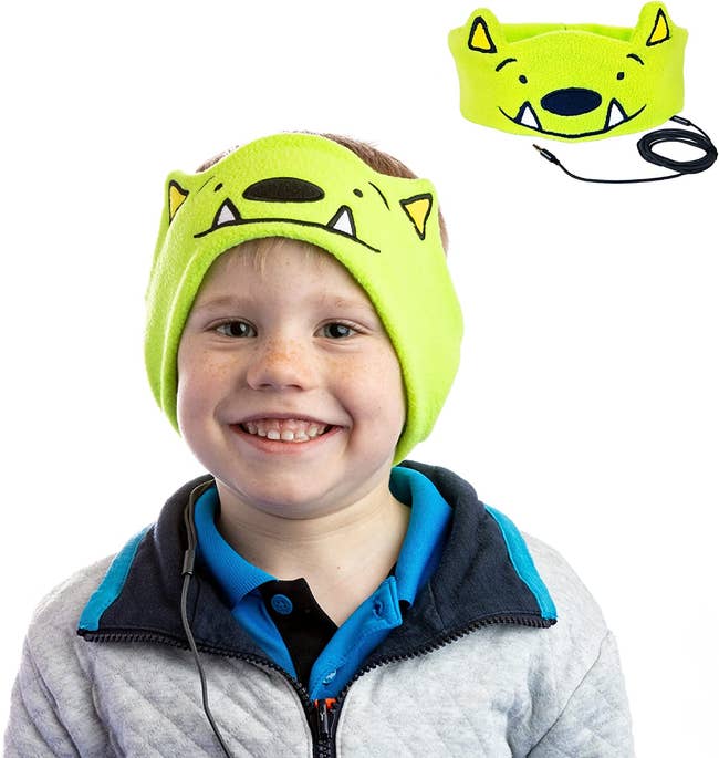 child wearing green monster headband headphones