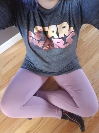 a reviewer sitting wearing the full length legging in light purple