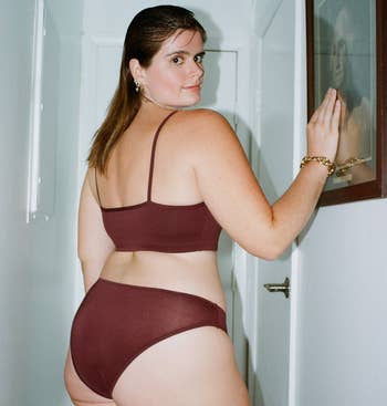 back of a model wearing a matching brown cotton underwear and bralette set