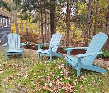 several light blue adirondack chairs outside