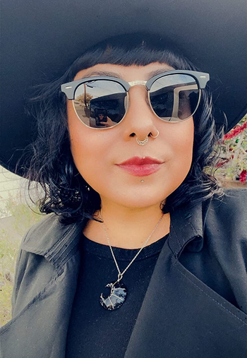 a reviewer wearing the black frames with silver metal
