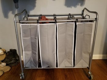 reviewer photo of their gray canvas rolling laundry sorter