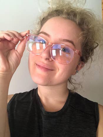 a reviewer in pink rimmed blue light glasses