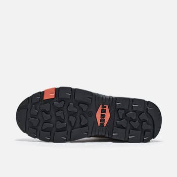 Sole of a sneaker with rugged, textured traction pattern designed for grip, featuring logos and durable construction