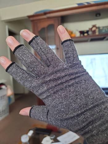 reviewer's hand in the gray glove