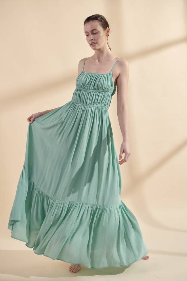 a model wearing the mint colored maxi dress 