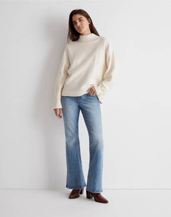 model wearing the cream top with jeans and boots