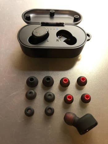 Wireless earbuds successful  a charging lawsuit  with assorted  receptor  extremity   sizes connected  display