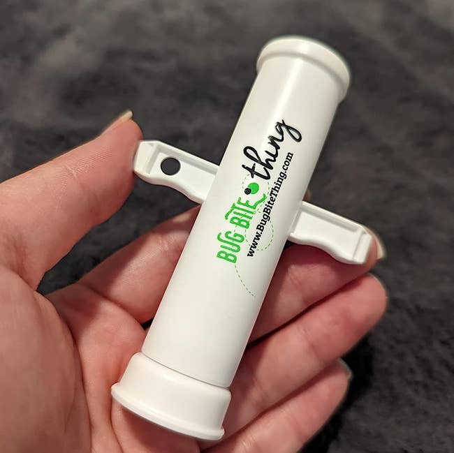 Reviewer holding the white Bug Bite Thing