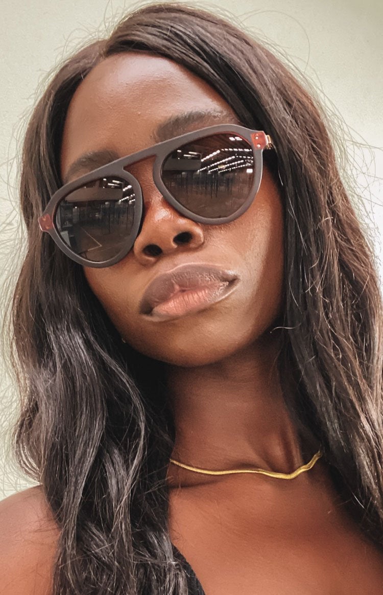 model in brown triangle lens sunnies