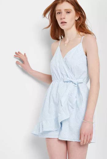 front view of a different model in a light blue romper