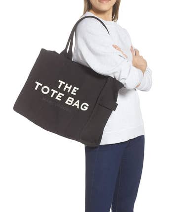 A model wearing the bag in black over their shoulder