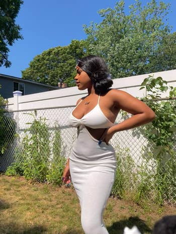 reviewer photo wearing white maxi cutout dress in the sunlight
