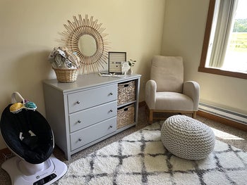 reviewer photo of the white rocking chair in a nursey
