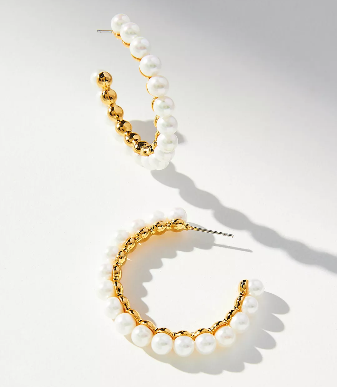 large gold hoops covered in glass pearls