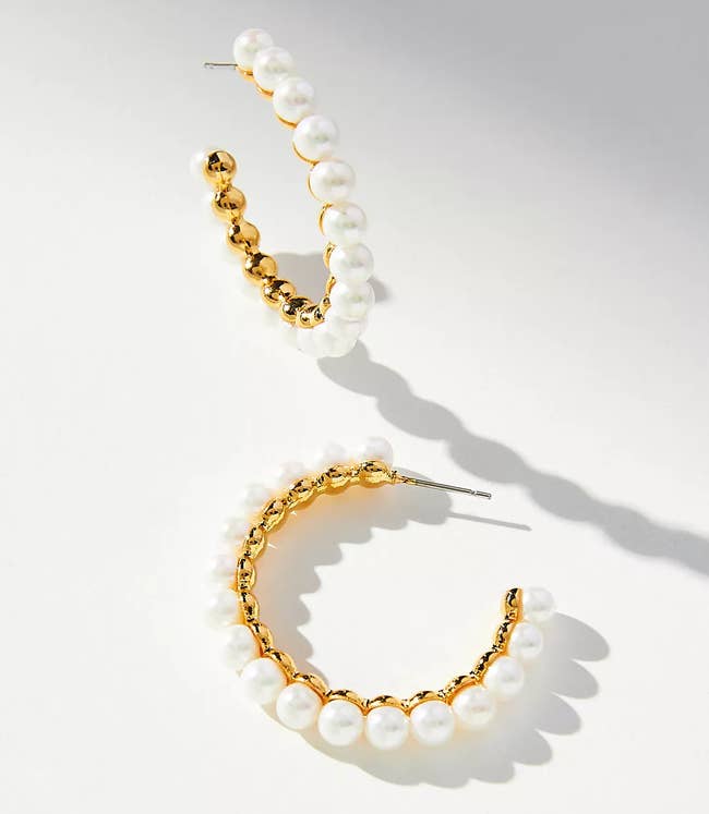 large gold hoops covered in glass pearls