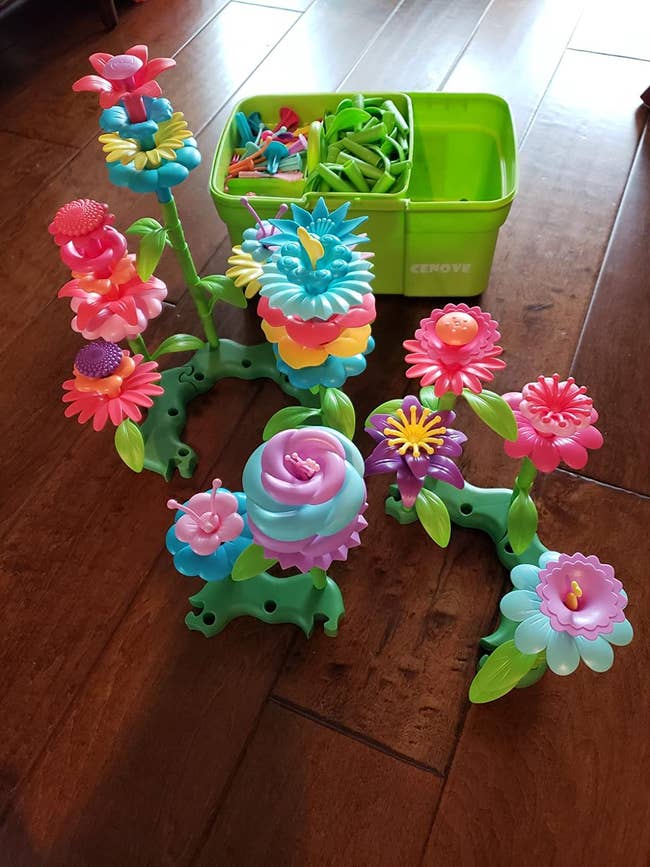 Reviewer&rsquo;s photo of plastic flower toys and bucket