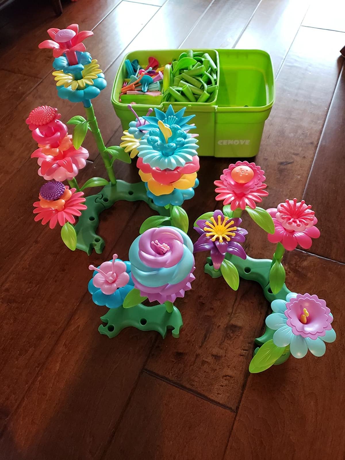 Reviewer's photo of plastic flower toys and bucket