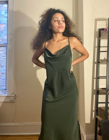a reviewer wearing the dress in forest green