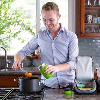 a model scooping soup into the thermos