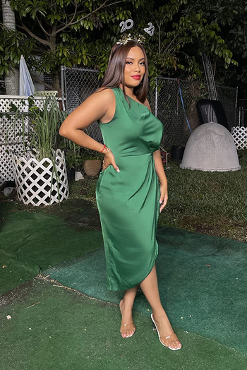 a reviewer posing in the green dress
