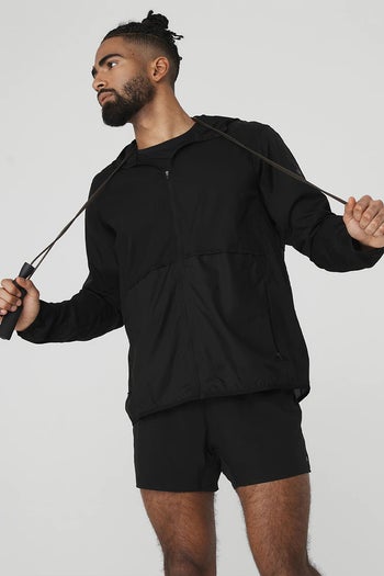 model in the black running jacket, zipped up