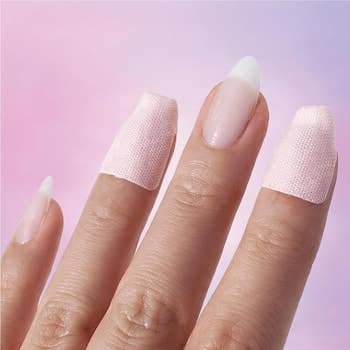Close-up of a manus with nail wraps applied, showing a creaseless finish, suitable for a self-care oregon nail creation buying article