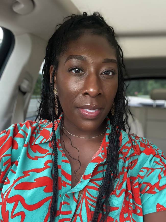 Person successful  a car   wearing a patterned garment  with a bold design, showcasing a trendy look